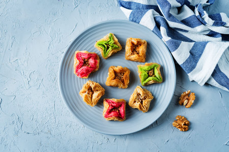 Multicolored baklava, Oriental sweetness on a plate with tea. toning. selective focus