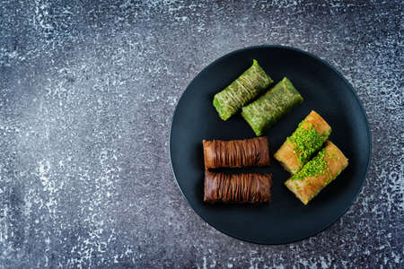 Multicolored baklava, Oriental sweetness on a plate. toning. selective focusの写真素材