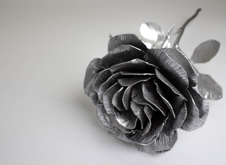 Hand forged rose. Rose handmade forged from metal on a white background.の写真素材
