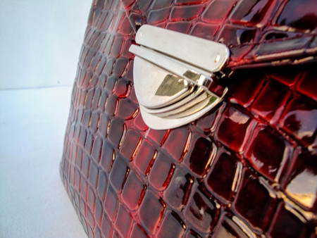 Handmade bag made of artificial leather on a white background. Women's  patent handbagの写真素材