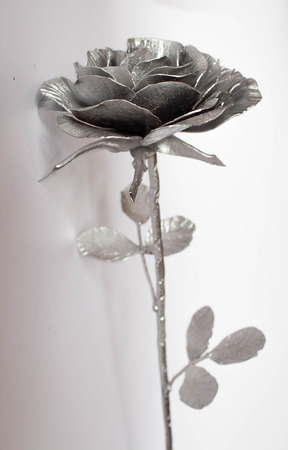 Hand forged rose. Rose handmade forged from metal on a white background.の写真素材