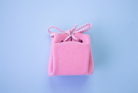 Pink gift box on a blue background. A colorful holiday gift. top viewの写真素材