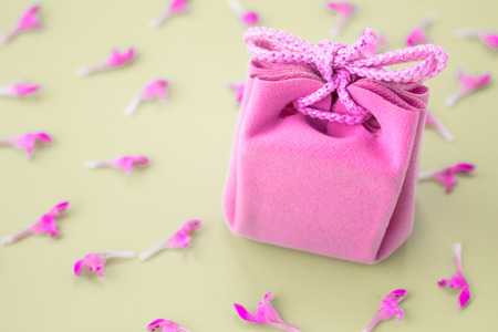 Pink gift card on a gray background with flowers. Beautiful delicate gift.の写真素材