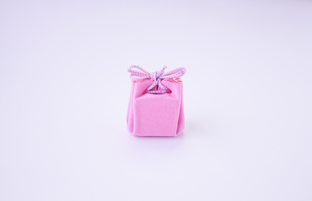 Pink gift box with ribbon for jewelry. Valentines Day, Womens Day, Mothers Day, Birthday, Wedding, Christmas. space for text.の写真素材