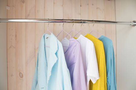 clothes of pastel shades on hangers. analysis of the wardrobe.の写真素材
