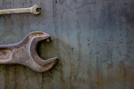 Old rusty wrench on a white and metal background. several wrenches of different sizes. Card with copy space for text.の写真素材