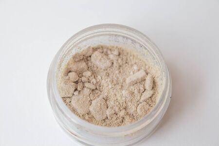 Texture of makeup powder - blush or eyeshadow. Mineral make-up cosmetics close-up isolated on white background.の写真素材