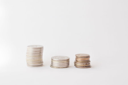  Three piles of coins on a white background. concept of money, finance, business. Berabota...