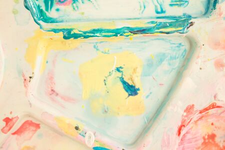 Mixing paints, close-up. Abstract colorful background, wallpaper with artist's palette.の写真素材