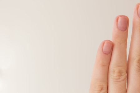 Removing cuticles and manicures at home with text space on a white background. Female fingers...