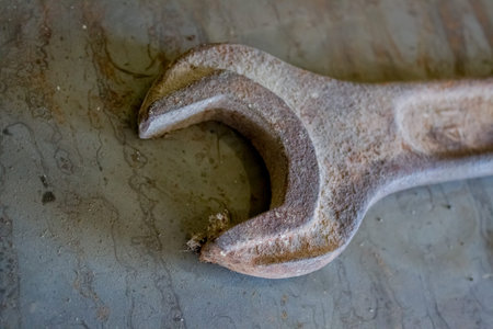 Old rusty wrench on a white and metal background. several wrenches of different sizes. Card with...