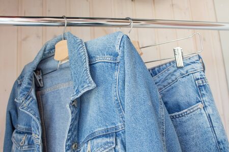 Jeans and jeans on a hanger. Fashionable denim outfit in blue wardrobe. Spring-summer collection, current jeans models.の写真素材