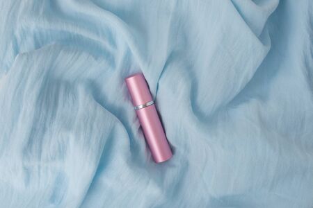 Natural cosmetic bottle mockup with organic anti aging product for skin care Metal bottle pink color on blue backgroundの写真素材