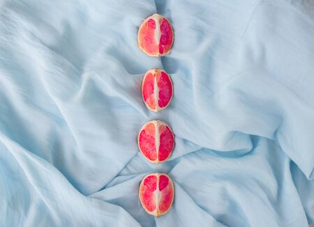 Flat lay blue natural background with grapefruit. Creative layout orange and grapefruit, minimal concept, top view.の写真素材