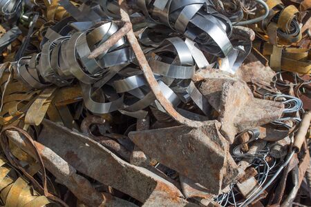 Pile scrap metal shavings isolated on white background. Scrap metal on recycling plant site.の写真素材