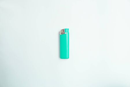  blue lighter with a button on a brown and white background. Top view. Mock up. Flat lay composition.の写真素材
