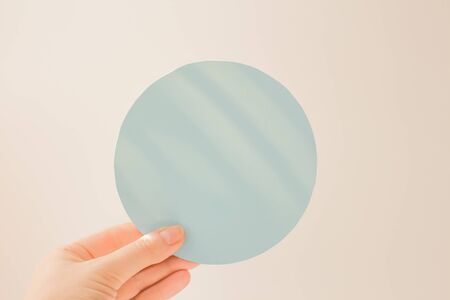 Paper circles, round blue cardboard mock up in hand. Blank template. Empty mockups of tags. Layout bank interest on loan.の写真素材
