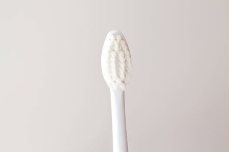 Soft toothbrush for gentle brushing on a beautiful white background close-up. Oral care layout with copy space. の写真素材