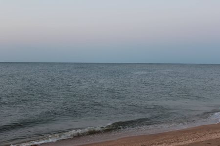 Silhouette of a camel at sunset on the beach. Twilight and a camel with two humps on the seashore.の写真素材