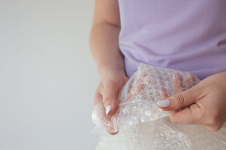 Cellophane film for packaging with air in female hands with copy space.