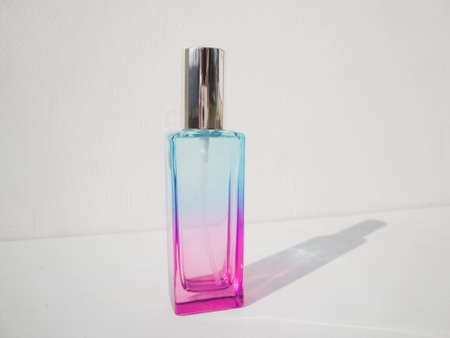 Elegant colored purple with blue rectangular perfume bottle. Cosmetic container with color gradient. Pink perfume botlle.の写真素材