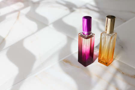 two perfume bottles. Hard shadows. Juicy color glass on a white background. Space under the text. layout.の写真素材