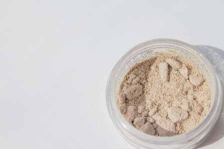 Texture of makeup powder - blush or eyeshadow. Mineral make-up cosmetics close-up isolated on white background.の写真素材