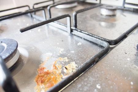 dirty stove close up. house cleaning concept. metal stove with contaminants from cooking. Dirty gas...