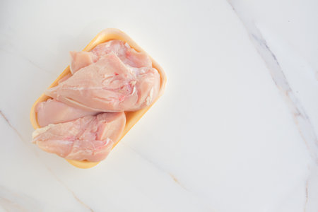 Fresh chicken meat in packaging only from the store. Chicken fillet on table with copy space.の写真素材