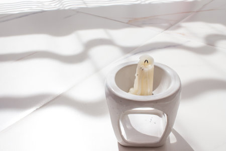 Flat layout magical with candles on white marble with a light shadow. Halloween mysticism and witchcraft conceptの写真素材