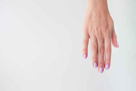 Regrown manicure. Female hand with regrown nails before correcting gel polish. Well-groomed hands. copy space trending. Place for text.の写真素材