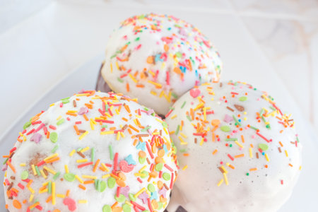 A set of Easter cakes in multi-colored sprinkles. Easter cakes on a festive table with Christian Easter bread.の写真素材