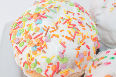 A set of Easter cakes in multi-colored sprinkles. Easter cakes on a festive table with Christian...