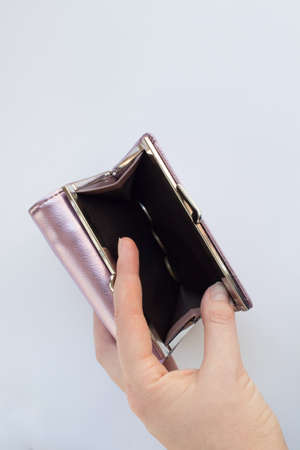Empty wallet in a woman's hand. Financial crisis concept. Unemployment, impoverishment, redundancies in enterprises.の写真素材