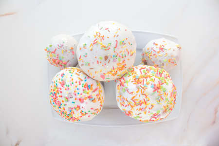 Easter holiday card with cakes and pies for happy saint easter day. White cream on an airy muffin with bright sprinkles of different colors. Happy easter concept. Copy space for your textの写真素材