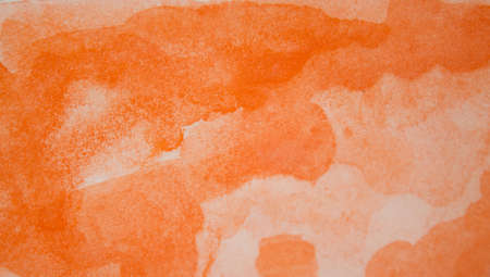 Orange watercolor background. Watercolor splash on paper in the form of abstraction. Orange gradient handmade.の写真素材