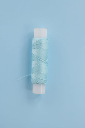 Sewing production concept. Repair of clothes, sewing a new collection for the season. Spool of white...