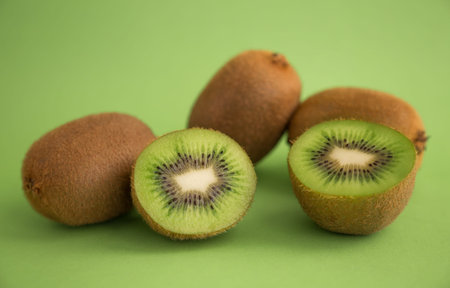 Kiwi a fruit with a thin hairy skin, green flesh, and black seeds.の写真素材