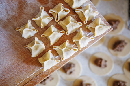 Dumplings and parsley - russian pelmeni. Cook dumplings. Pasta ravioli