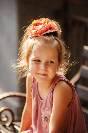 Close-up portrait of a lovely urban little girl outdoorsの写真素材