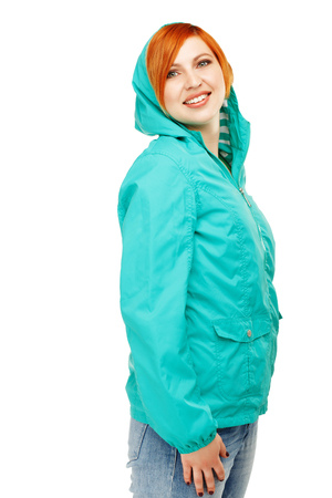 Portrait of a young beautiful girl in a jacket with a hood isolated on white background. The onset of cold weather. Change of winter clothing for spring. Weather forecast, metcastの写真素材