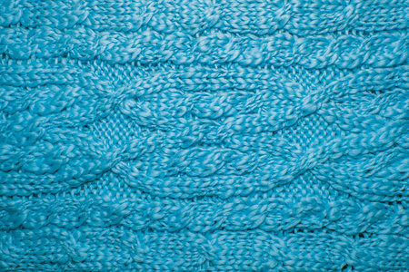Wool sweater or scarf texture close up. Knitted jersey background with a relief pattern. Braids in...