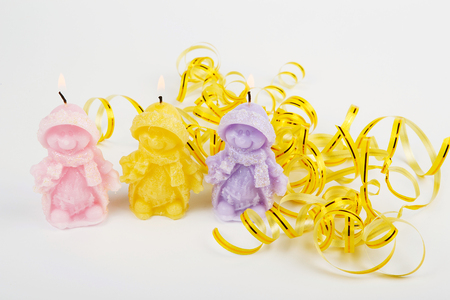 Colorful handmade candles in the shape of snowmen. Funny Christmas candles. Souvenir Christmas candle on a white backgroundの写真素材