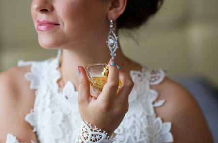 bride applying perfume. Bride spraying perfume on her neckの写真素材