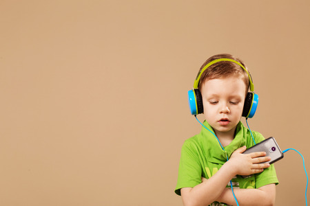 little boy in the headphones enjoy musicの写真素材