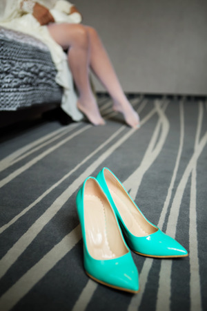 Bride dresses shoes before the wedding ceremony. Bride attributes. Morning of the bride. Preparations for the wedding ceremonyの写真素材