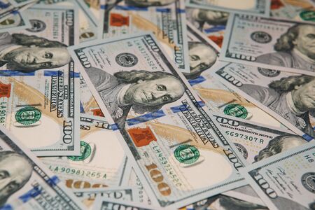 Background of 100 dollar bills. pile of hundred dollars bank notes. Money background - hundred american dollarsの写真素材