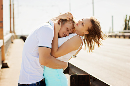 Man and woman kissing and embracing on the bridge. Couple in loveの写真素材