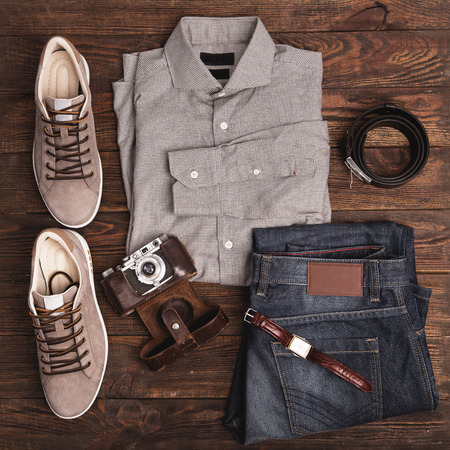 set of stuff with camera and other travel things on wooden table backgroundの写真素材