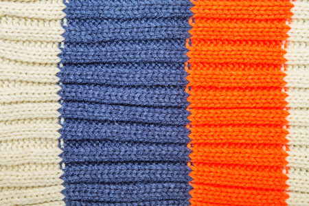 Close up on knit woolen fur texture. Color woven thread sweater or scarf as a background.の写真素材